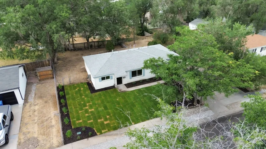 Ranch-style residence featuring a newly sodded front lawn and fresh landscaping beds