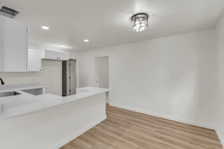 Kitchen and dining area featuring light wood-finish flooring