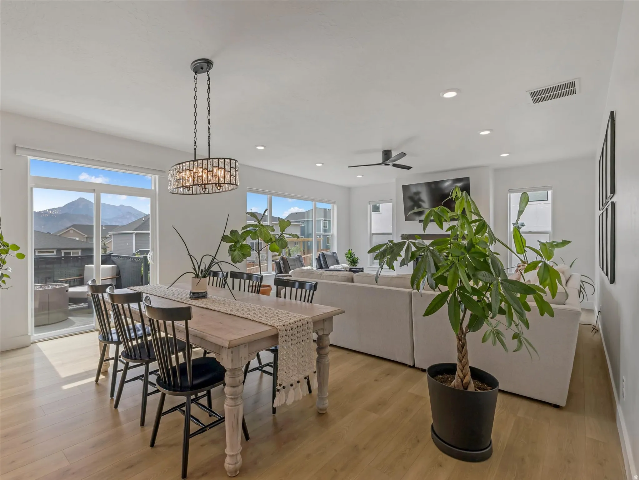 Open-concept living space with light wood-finish flooring