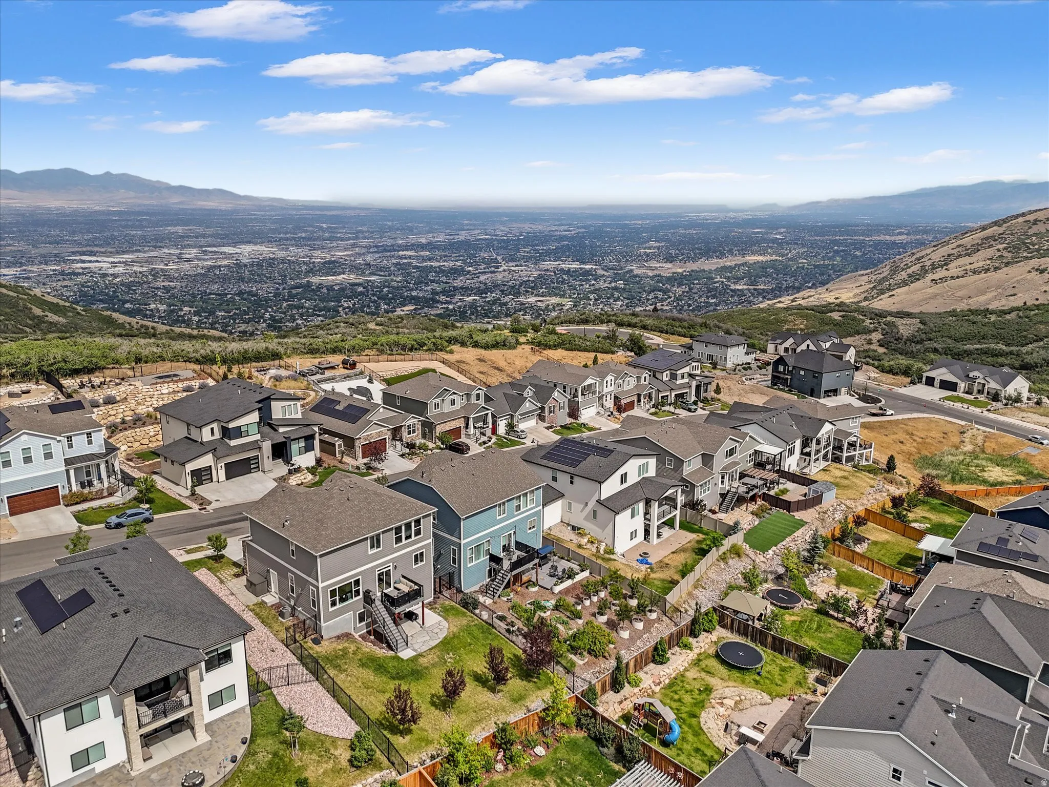 Elevated residential neighborhood featuring varied contemporary home designs with solar panels