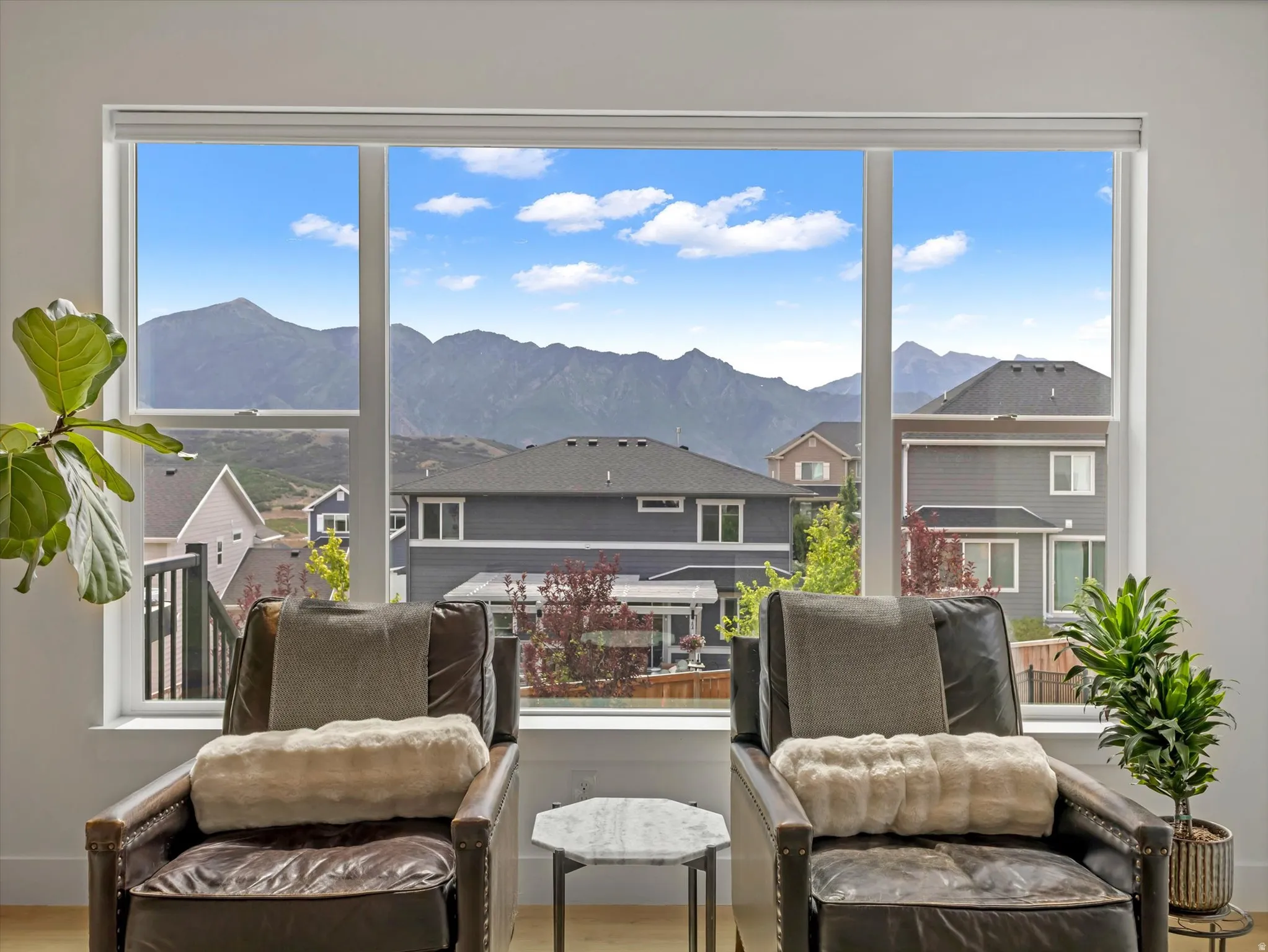 Expansive window offering mountain scenery and surrounding properties