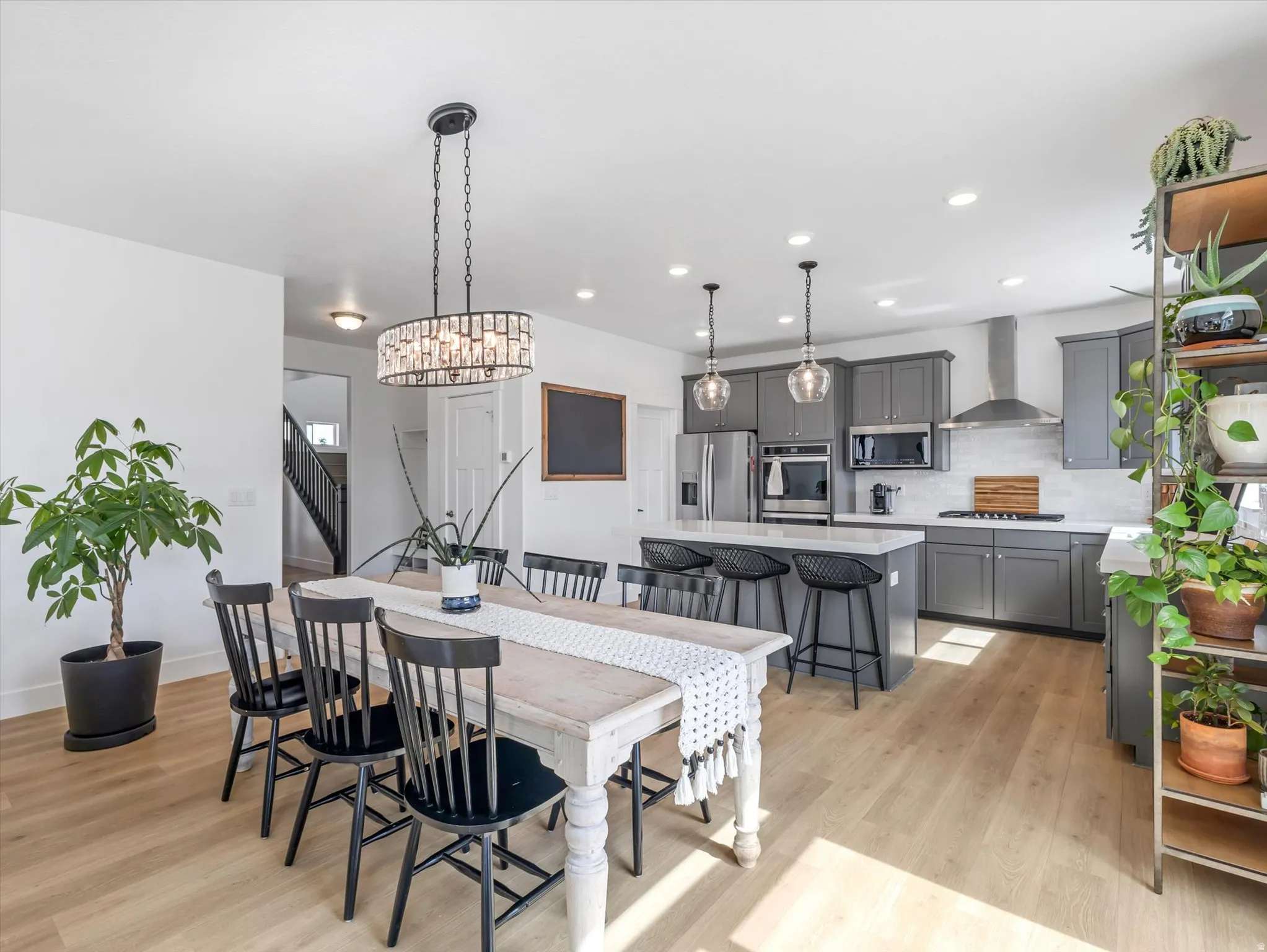Open-concept dining and kitchen area featuring wood-finish flooring