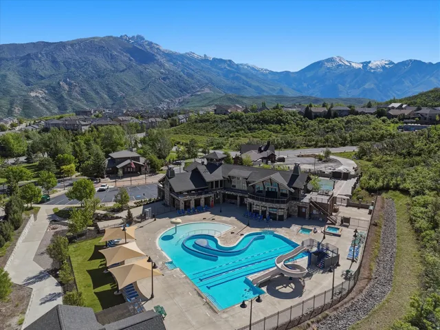 Community clubhouse with multiple swimming pools, water slide, and two hot tubs