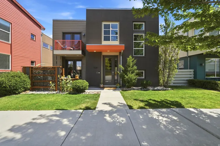 Contemporary multi-level residence featuring a dark gray facade with orange accents