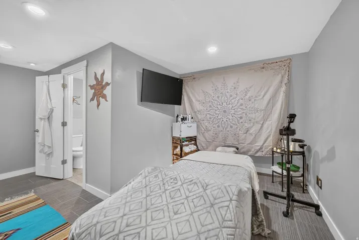 Gray-painted room featuring recessed lighting and gray plank flooring