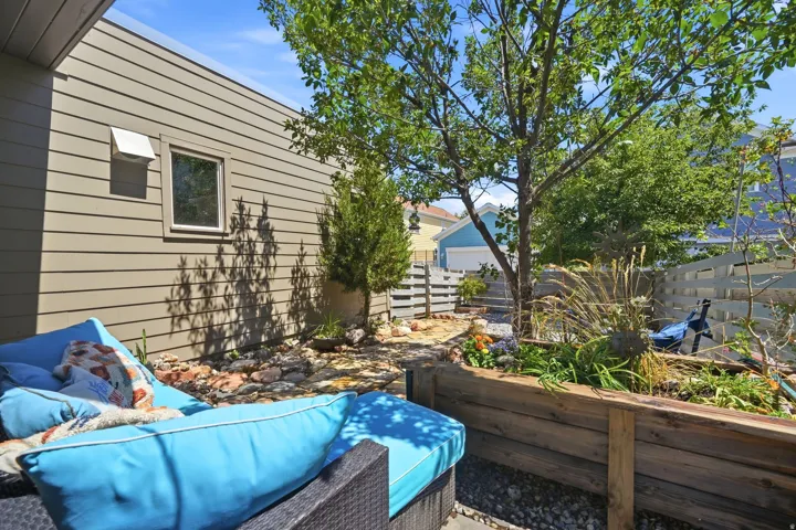 Private exterior patio featuring horizontal siding and a single window