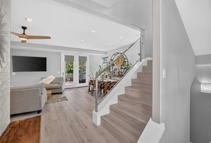 Modern staircase with cable railing system and wood-finish treads
