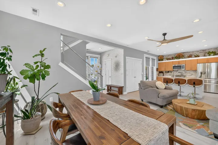 Dining area featuring a wood-finish table, recessed lighting, and light-tone flooring