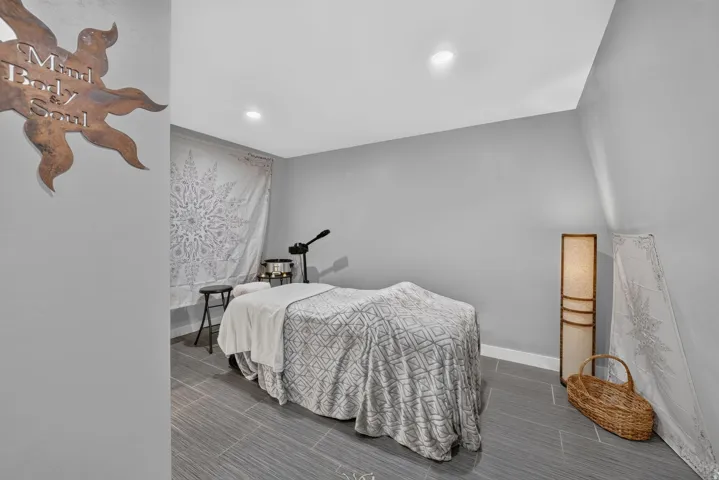 Finished room featuring recessed lighting, light gray wall paint, and gray tile flooring