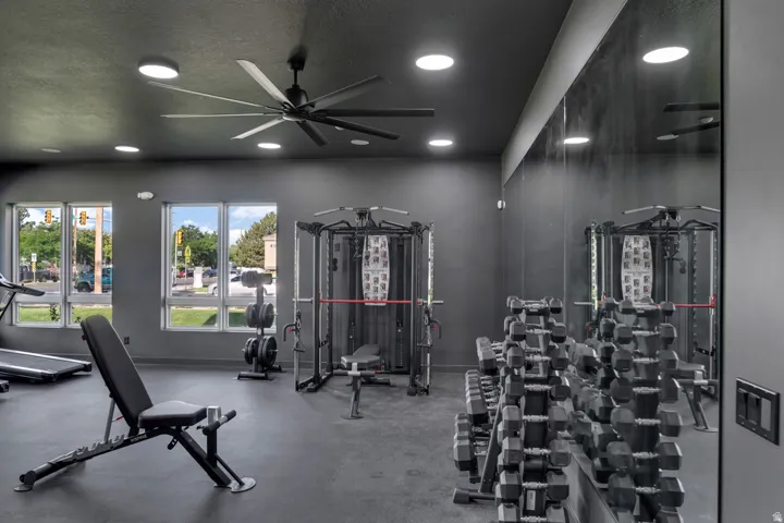 Fitness area with recessed lighting, a ceiling fan, and rubber flooring