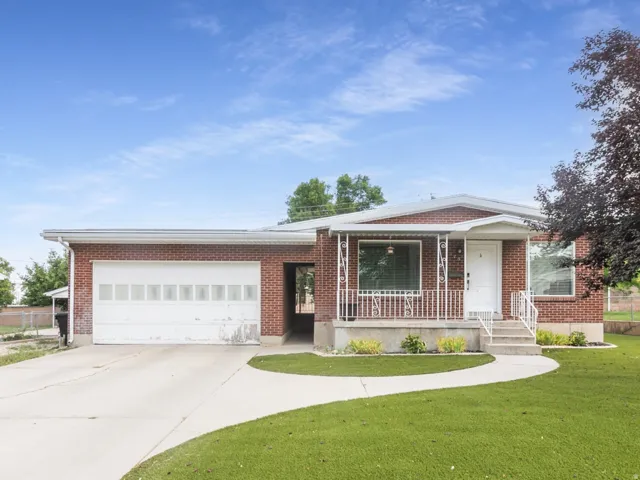 All-brick rambler with artificial turf for easy care and maintenance.