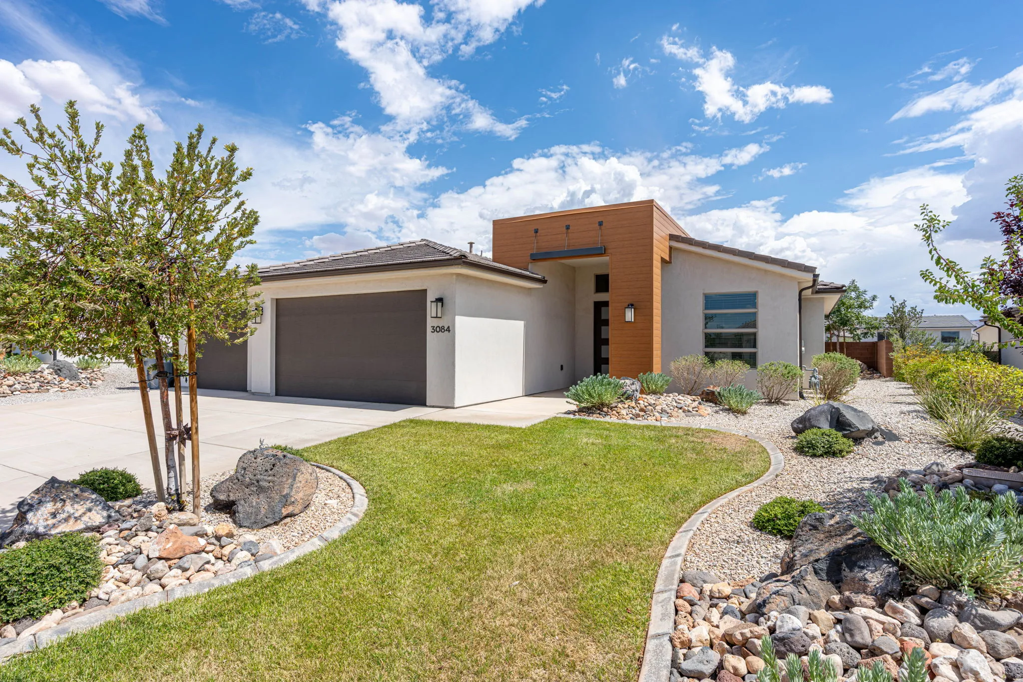 Contemporary stucco exterior with wood-tone accents