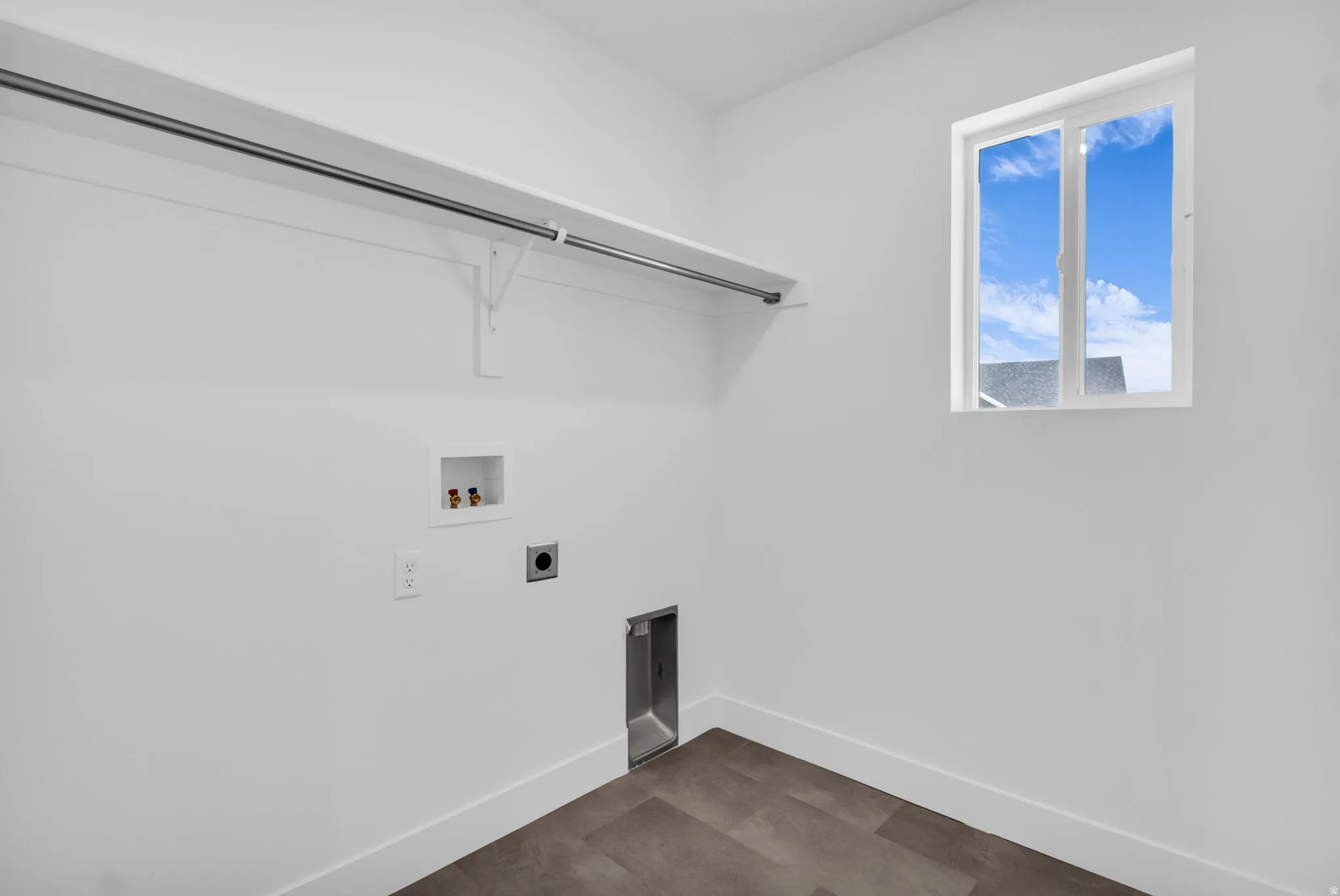 Full-size laundry room with natural light and washer/dryer hookups.