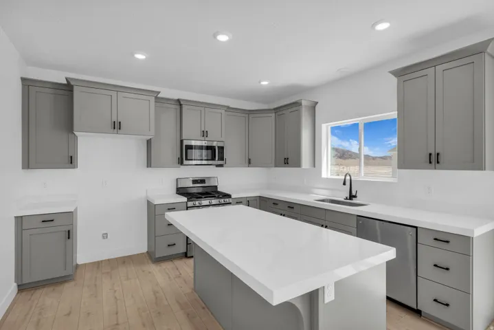 Great kitchen with 42" uppers, painted wood cabinets, quartz slab countertops, gas range, microwave, dishwasher and disposal.