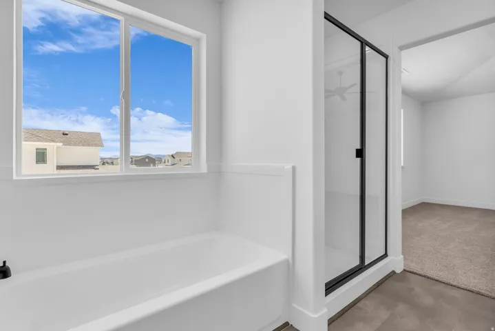Primary bath with soaker tub and walk-in shower.