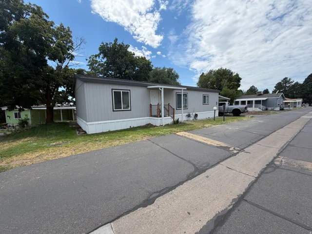 Light gray siding with white trim and a covered front entry
