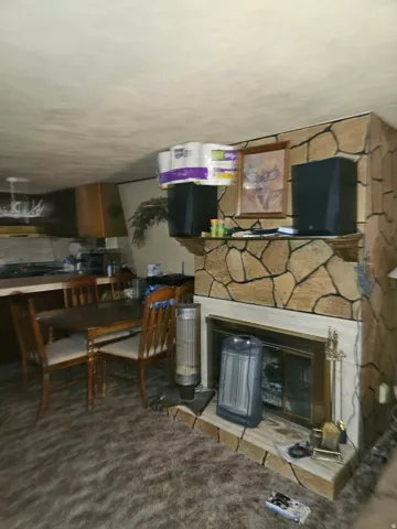 Stone-clad fireplace with a brass firebox and a stone hearth