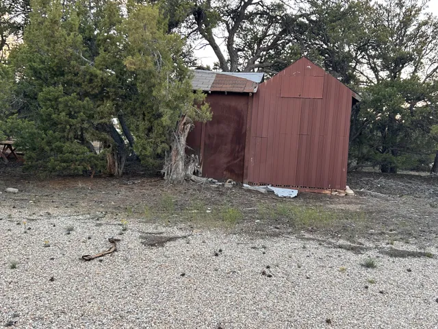 Red-sided utility shed with metal roofing