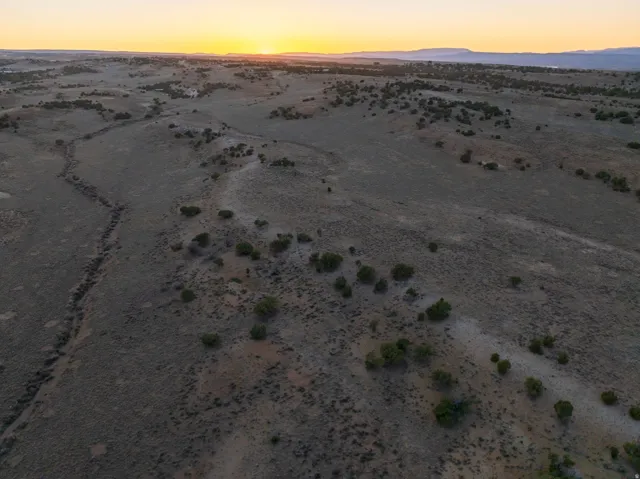 Expansive, undeveloped acreage featuring natural topography and scattered vegetation