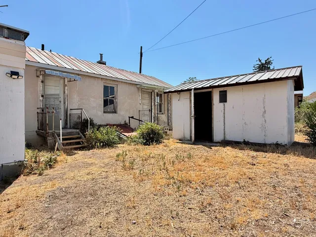 Detached mother-in law house with a metal roof and light-colored siding