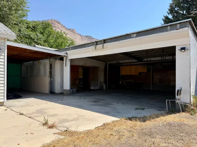 Concrete driveway leading to a multi-bay garage structure