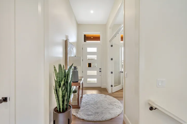 Modern entry hall featuring 5 panel glass front door