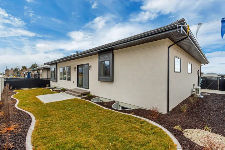 Exterior featuring included landscaping and fencing