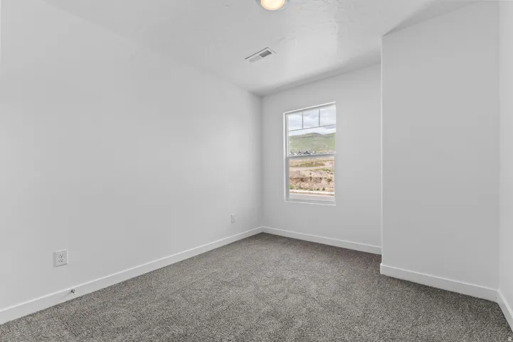 Room featuring light gray carpet, white walls, and white baseboards