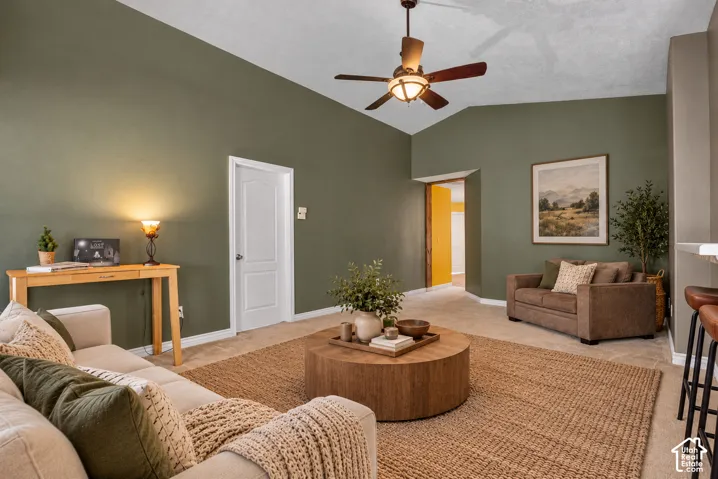 Vaulted ceilings and a central ceiling fan with an integrated light fixture. Virtually Staged.
