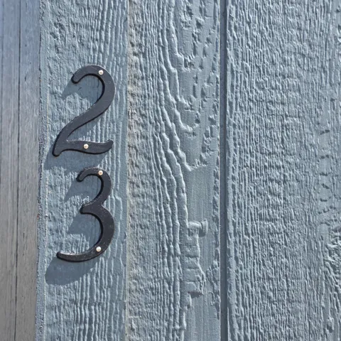 Vertical board siding in a light blue finish featuring visible wood grain texture
