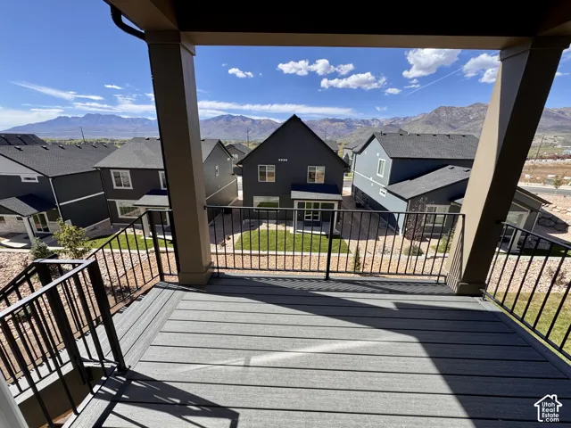 Deck with composite decking, black metal railing, and mountain backdrop