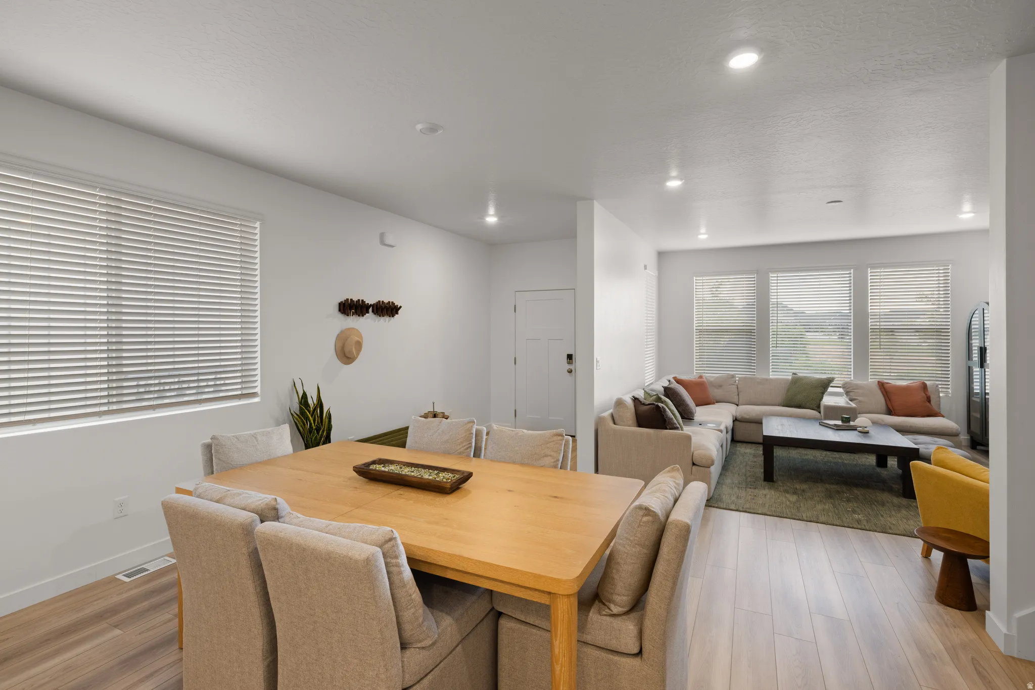 Open-concept living area with light wood-finish flooring