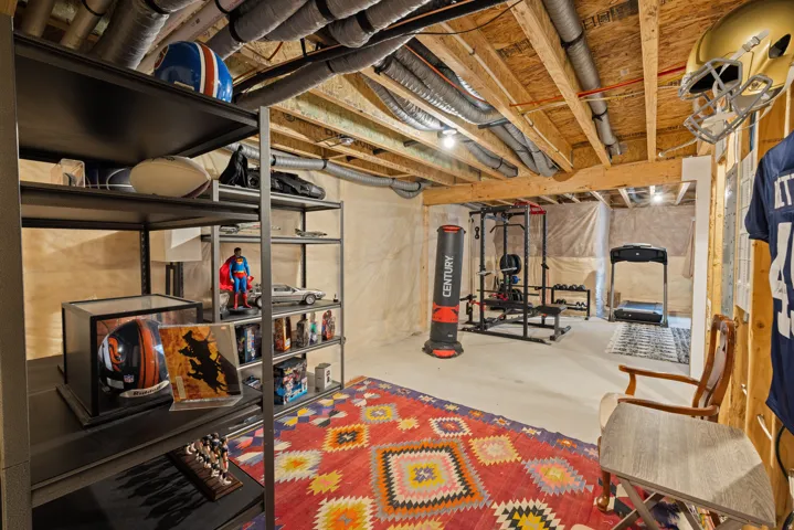 Unfinished basement storage area with concrete flooring, and flexible open space
