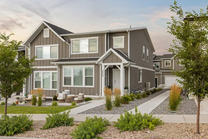 Contemporary two-story exterior featuring vertical plank siding with white trim accents