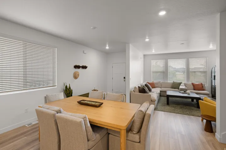 Open-concept living area with light wood-finish flooring