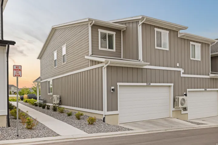 Gray siding exterior with white trim details and multiple windows