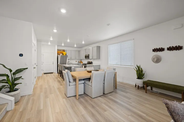 Open-concept living space featuring wood-finish flooring, recessed lighting, and a modern kitchen