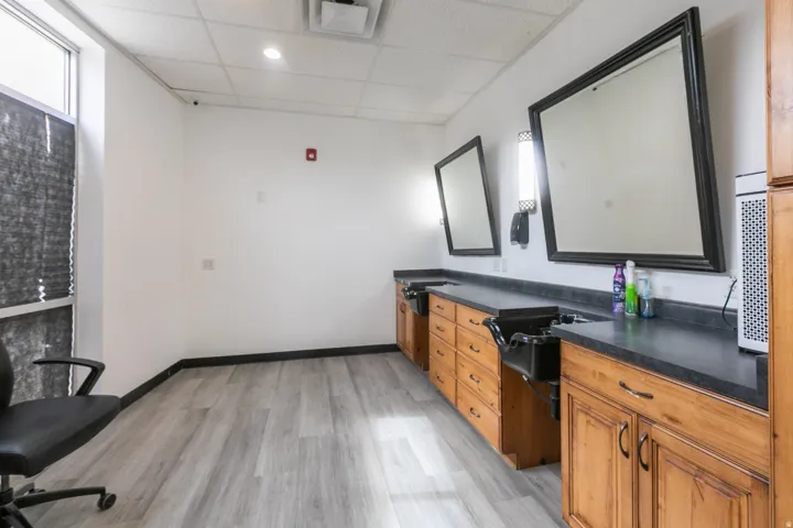 Commercial space featuring light wood-finish flooring and a drop ceiling with recessed lighting