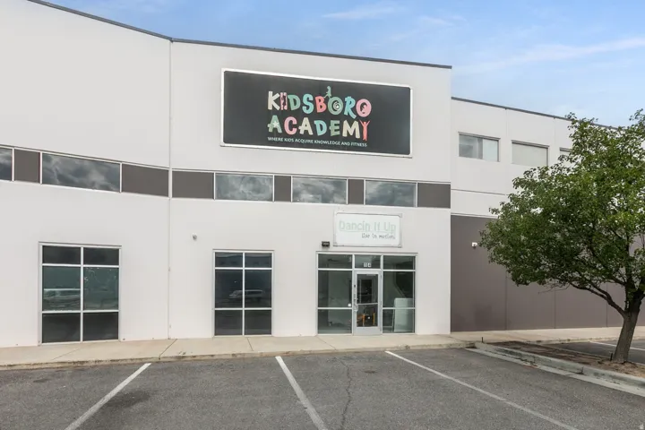 Commercial building with a light-colored facade and dark trim