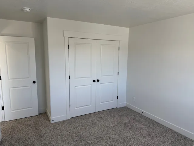 Neutral-toned carpet flooring complementing bright white walls