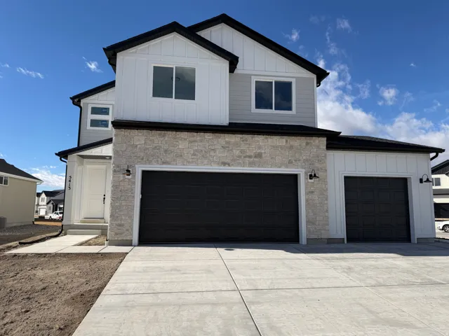 Contemporary two-story exterior featuring a stone and siding facade