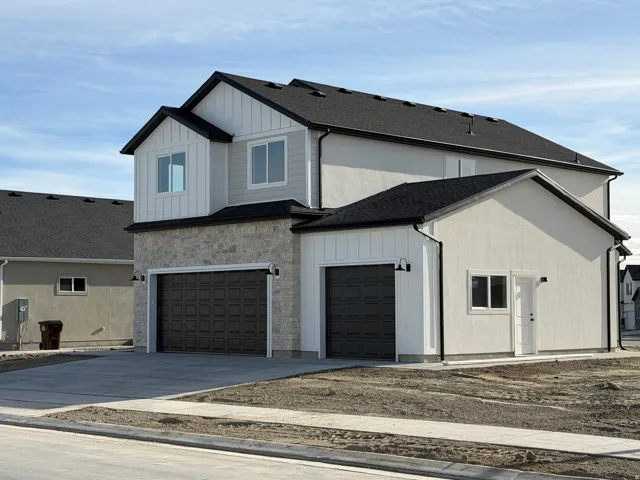 Contemporary exterior with multi-textured facade including board and batten siding and stone accents