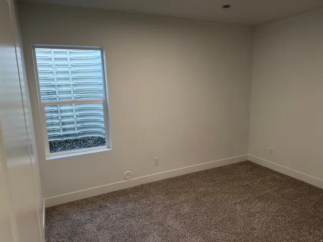 Neutral tone wall finishes complemented by crisp white baseboards