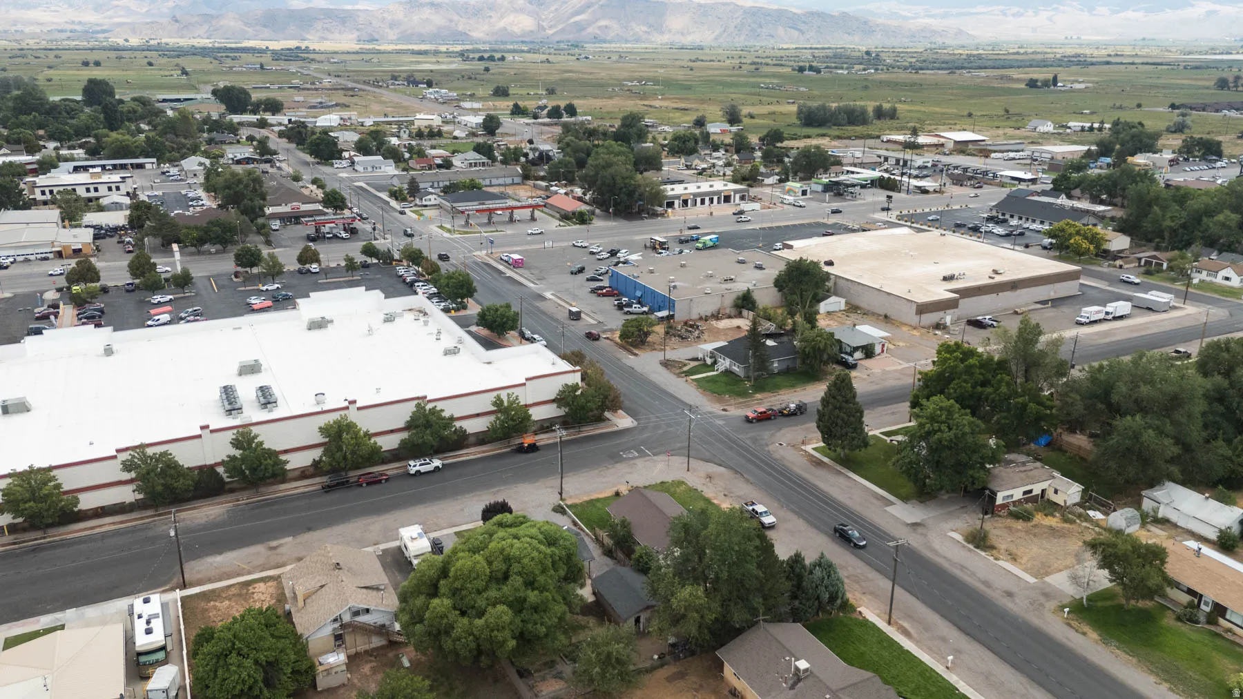 Aerial perspective showcasing a commercial district with multiple buildings and expansive parking areas