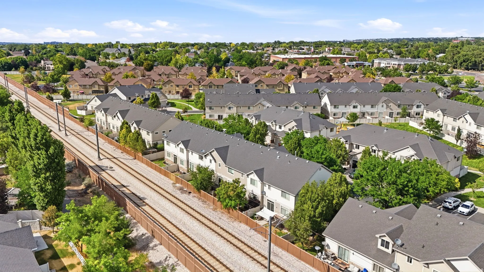 Aerial panorama showcasing a residential development with multiple townhome-style buildings