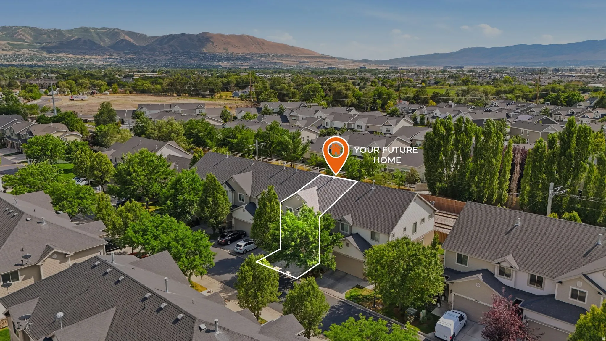 Aerial perspective showcasing a residential community with distant mountain scenery