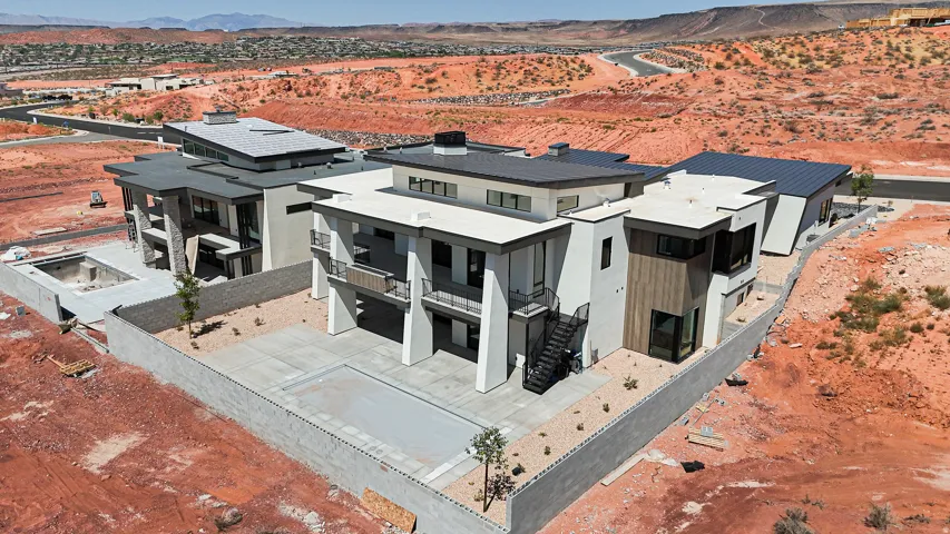 Contemporary architecture with multiple flat roofs, multi-level construction, exterior staircase, and an integrated swimming pool