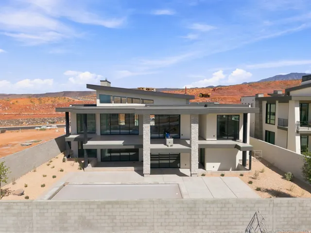 Contemporary multi-level exterior with extensive glazing, stone accents, and flat rooflines