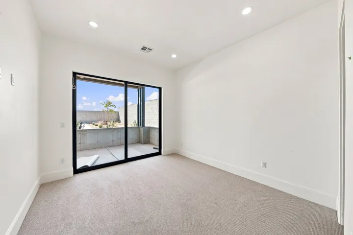 Sliding glass door leading to a concrete patio