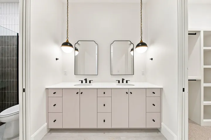 Double vanity with white countertop, dual undermount sinks, and matte black fixtures